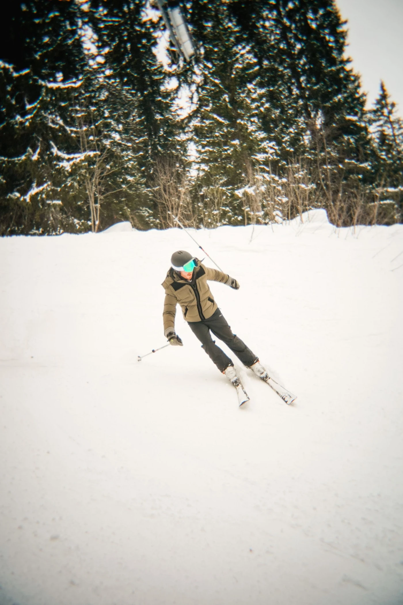 A member of the 2026 group skiing on the snowy mountain slopes.