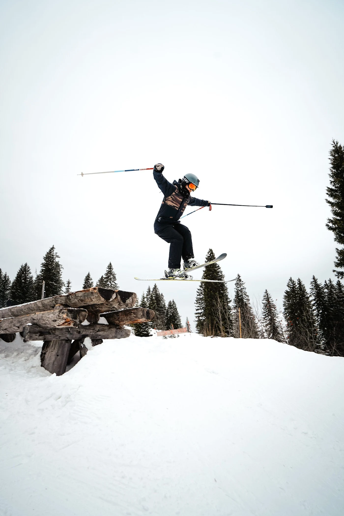 A skier from the 2026 trip jumping over a snow-covered ramp.