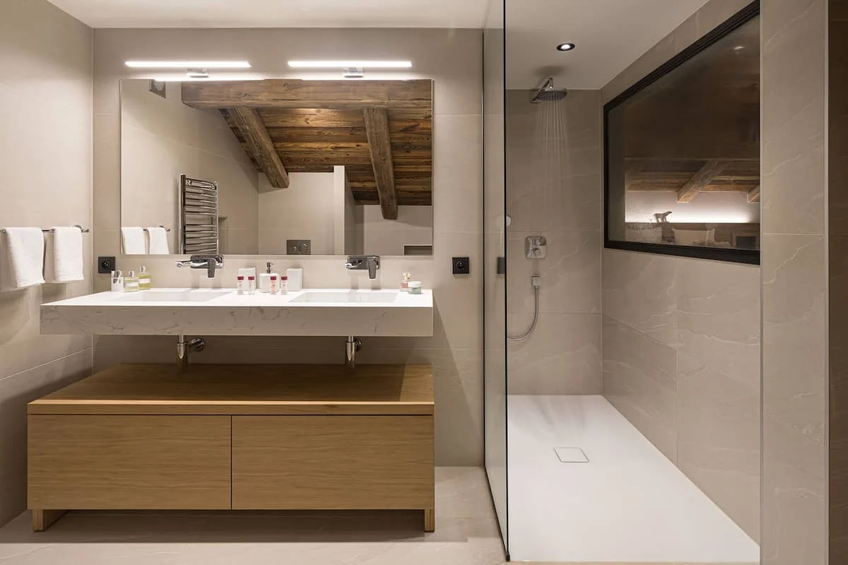 A contemporary chalet bathroom in natural stone and wood.