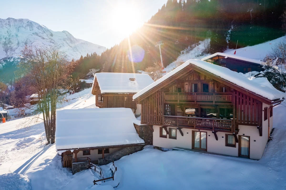 The luxury chalet set against its snowy mountain surroundings.